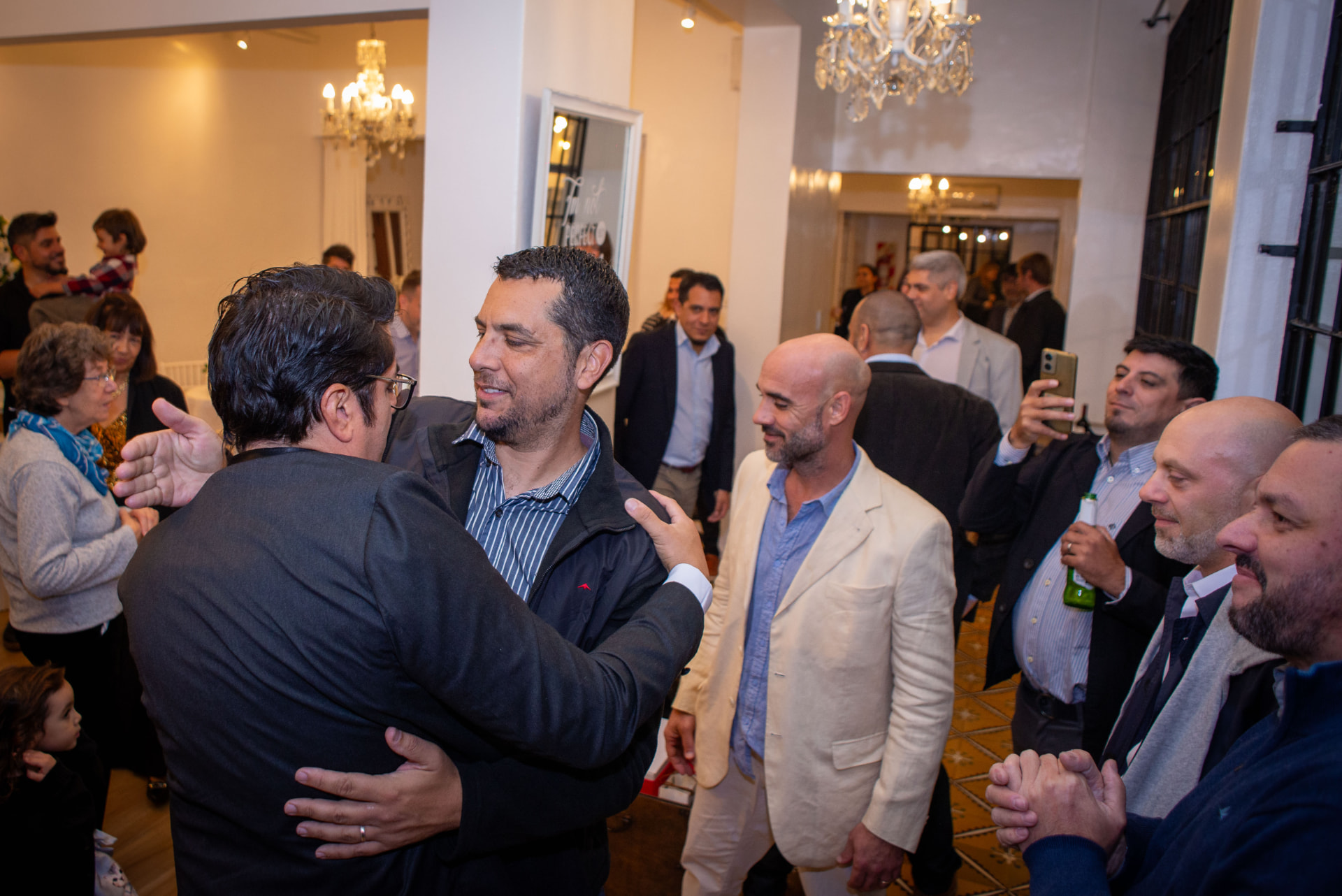 Invitados saludándose en el salón principal